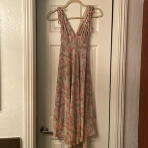 Beautiful flowered dress with tie in the back for different sizing.